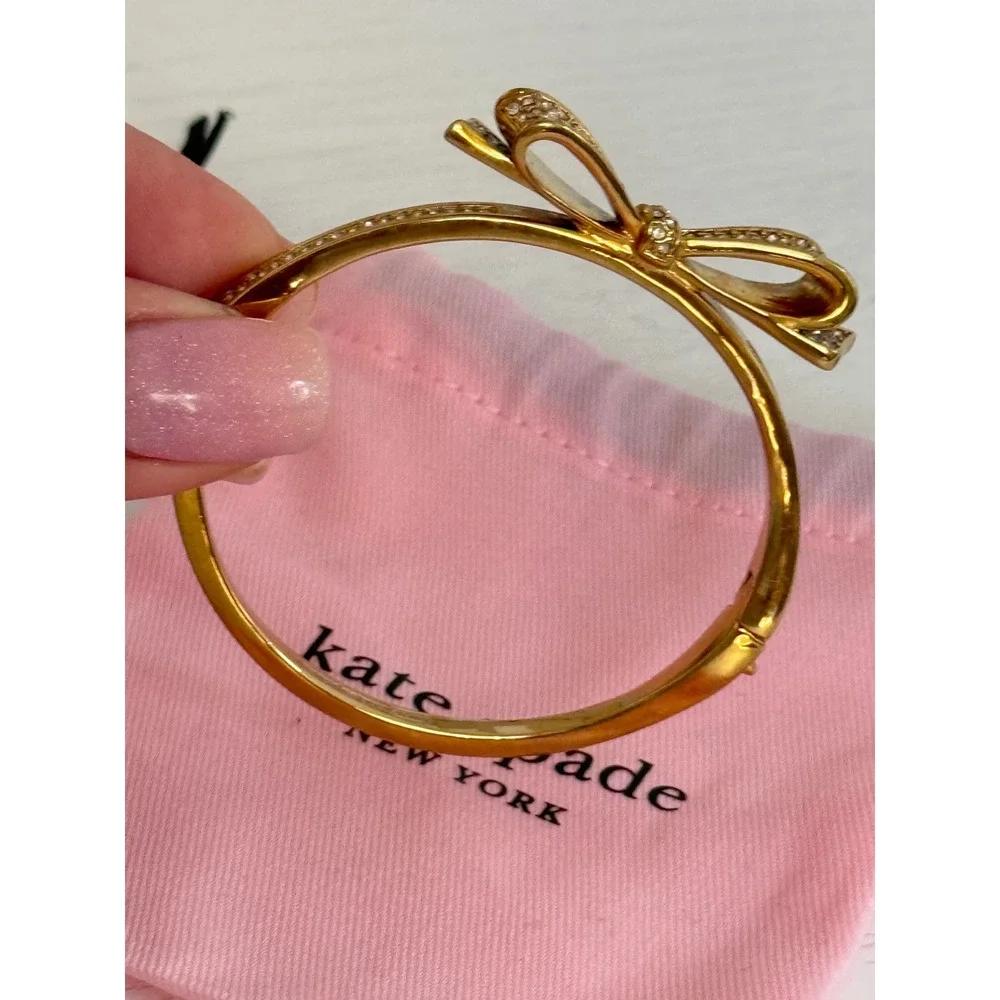 Kate Spade New York Gold Tone Pave Crystal Bow Hinged Bangle Bracelet with Bag